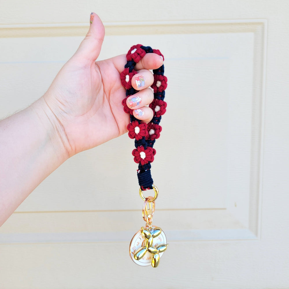 Blue and Maroon Flower Macrame Wristlet Keychain with gold clip hanging on hand