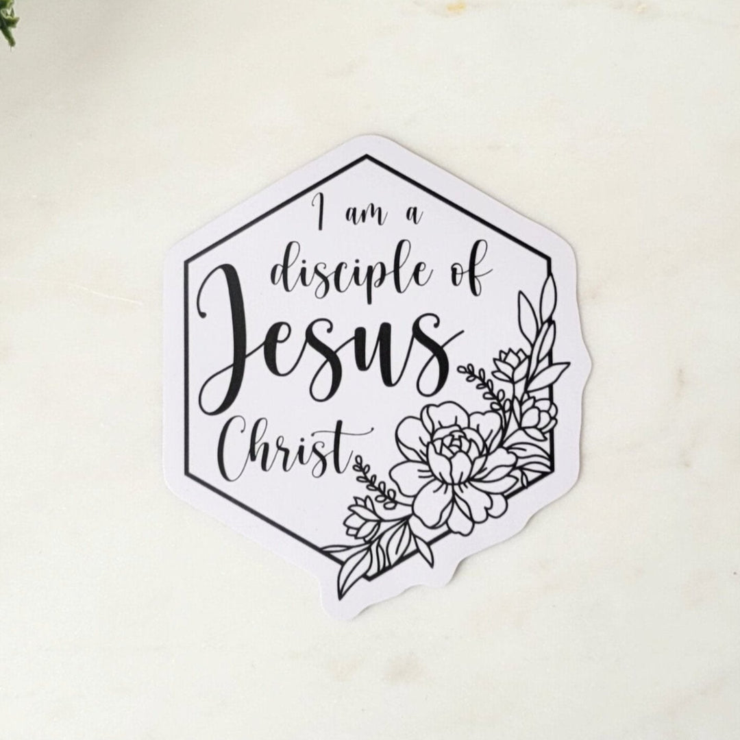 white hexagon shaped sticker, with "I am a Disciple of Jesus Christ" lettering, with flowers, all in black outlines