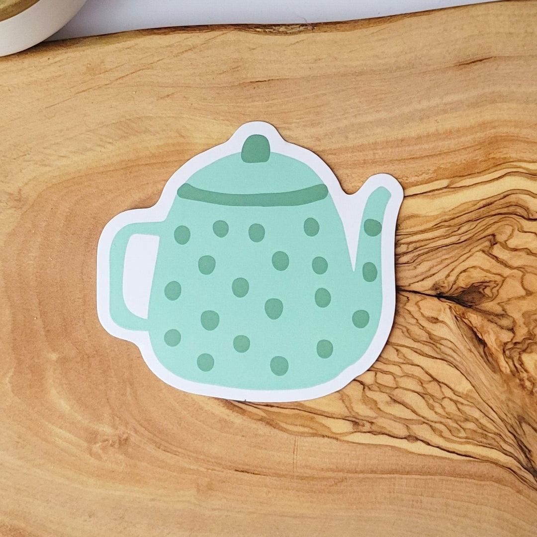 a green tea pot with darker green spots