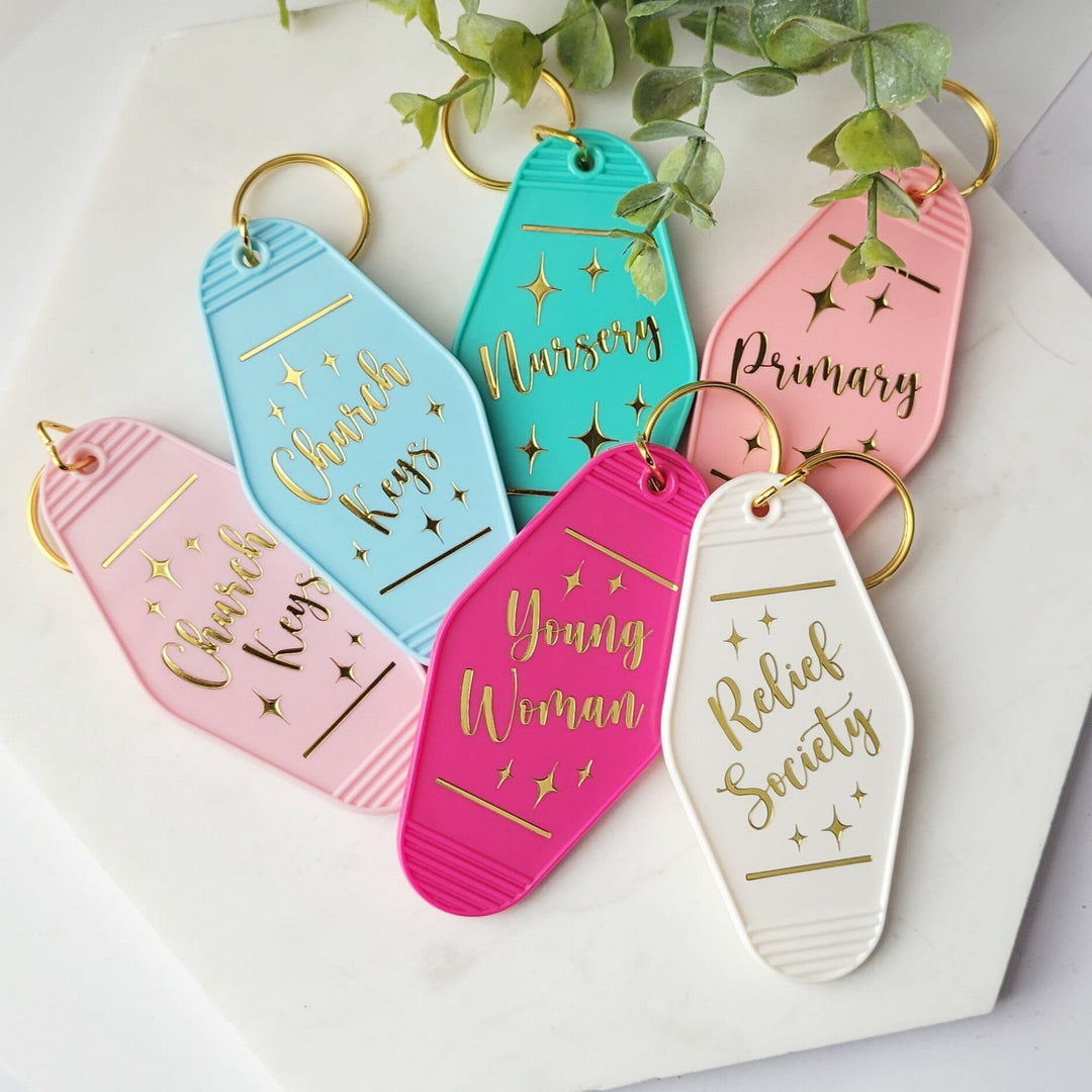 a group of retro style motel keychains, with gold rings, with several says on the front. "Church keys, Nursery, Primary, Young Woman, and Relief Society."