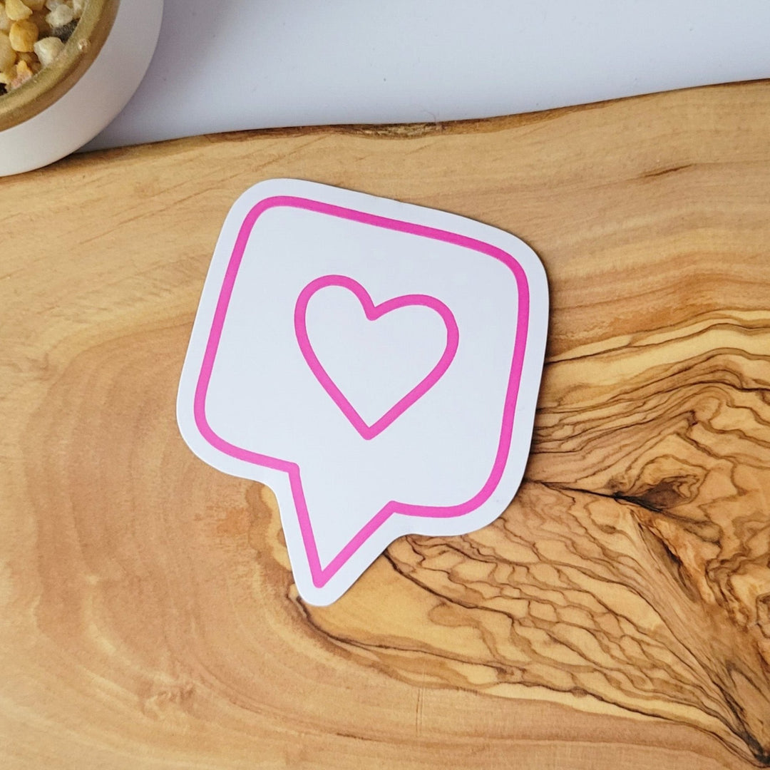 a white sticker of a pink outline of a conversation bubble, with a pink heart outline in the middle