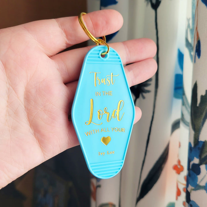 "Blue retro motel-style keychain with gold foil on both sides, featuring 'Church Keys' on the front and 'Trust In the Lord With All Your Heart' on the back, with a gold ring