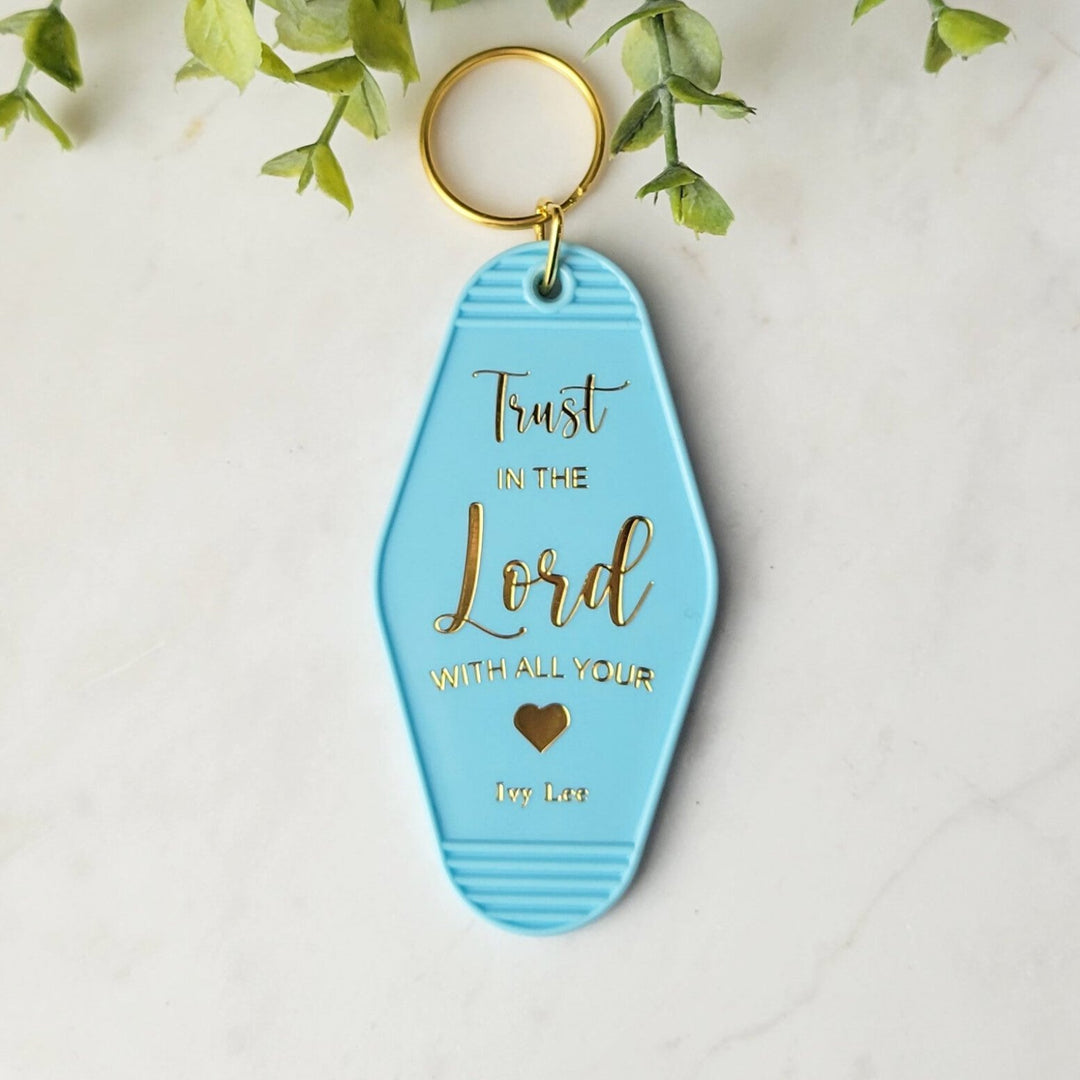 "Blue retro motel-style keychain with gold foil on both sides, featuring 'Church Keys' on the front and 'Trust In the Lord With All Your Heart' on the back, with a gold ring