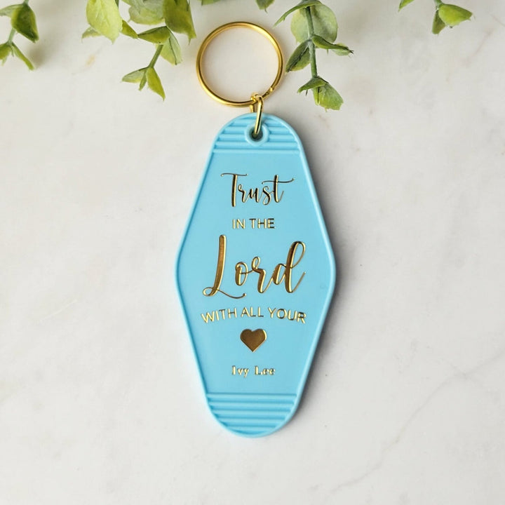 "Blue retro motel-style keychain with gold foil on both sides, featuring 'Church Keys' on the front and 'Trust In the Lord With All Your Heart' on the back, with a gold ring