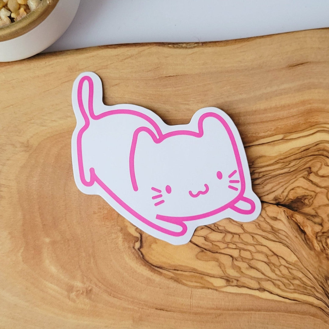 A white sticker of a pink outline of a cat, stretching outwards