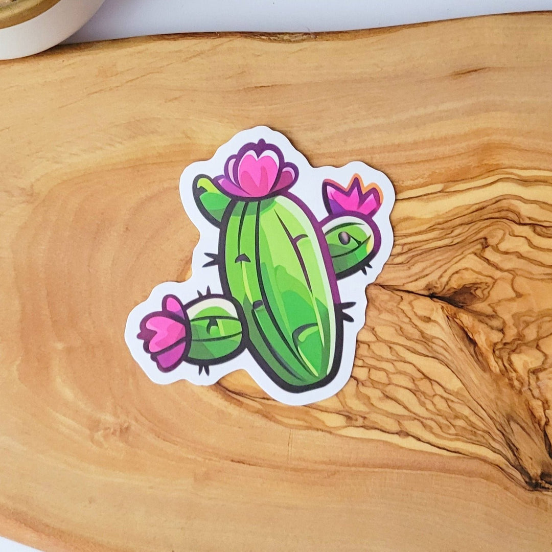 A sticker of a green cactus with pink and purple flowers