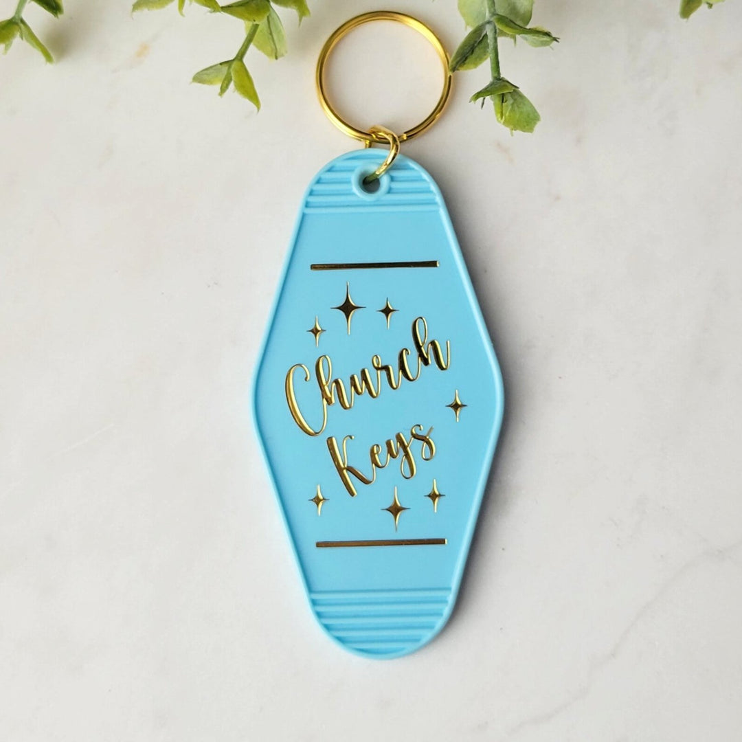 "Blue retro motel-style keychain with gold foil on both sides, featuring 'Church Keys' on the front and 'Trust In the Lord With All Your Heart' on the back, with a gold ring