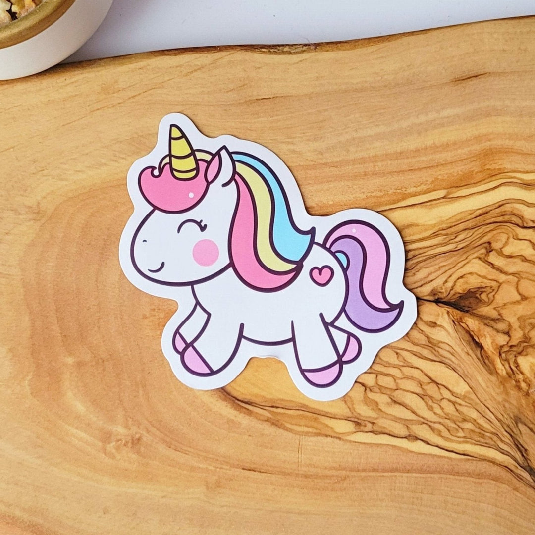 A happy unicorn with pink, yellow, blue, and purple hair.