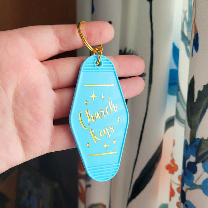 "Blue retro motel-style keychain with gold foil on both sides, featuring 'Church Keys' on the front and 'Trust In the Lord With All Your Heart' on the back, with a gold ring