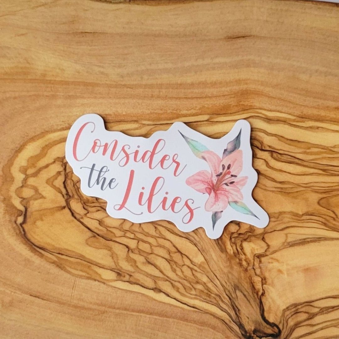 a sticker with Consider the Lilies font, and a pink lily flower.