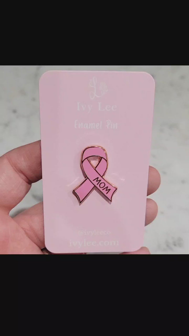 a video showing a pink breast cancer pin with in a video