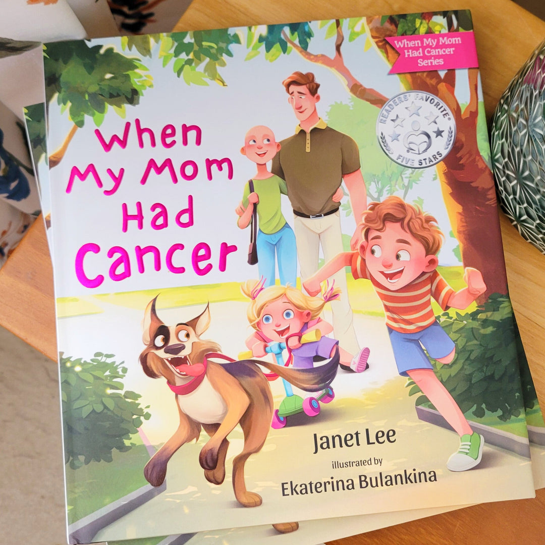 Book titled 'When My Mom Had Cancer' by Janet Lee on a wooden surface.